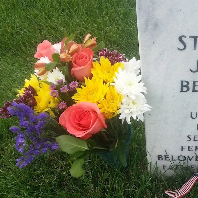 A flower bouquet near a headstone